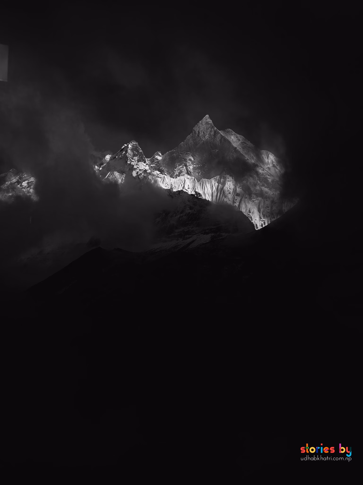 Peak of Mount Fishtail seen from clouds