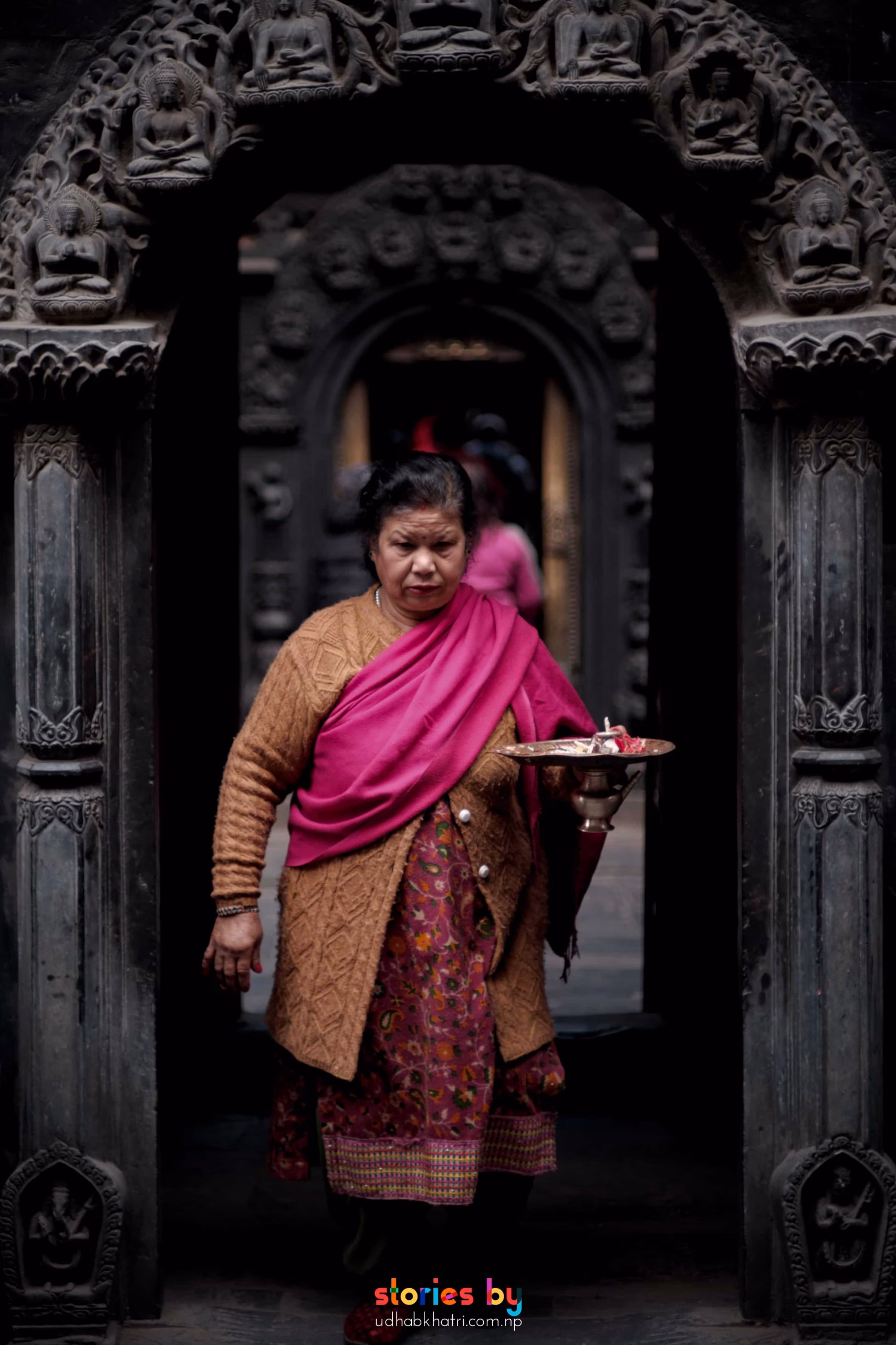 a woman walking at main entrance of golden temple after morning prayer